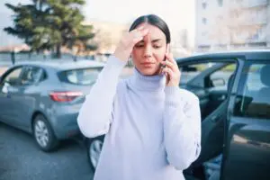 Woman on phone after car crash accident in Sacramento, CA