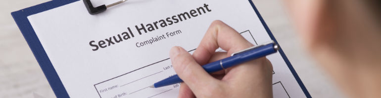 woman filling out sexual harassment complaint