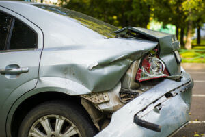 gray car with damaged bumper