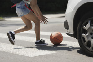girl-pedestrian-chasing-basketball