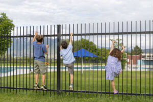kids-climbing-pool-fence