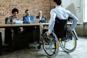 man-wheelchair-panel-brick-wall