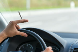 driver holding marijuana joint