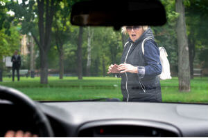 woman-pedestrian-black-coat-blonde-short-hair