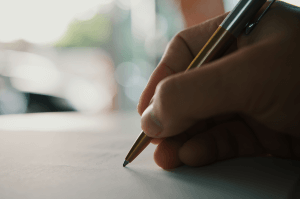 Person writing a letter