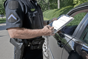 Police officer writing traffic ticket