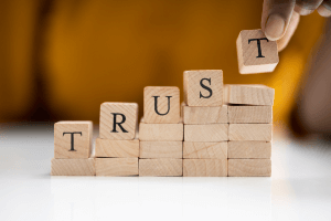 building blocks with the word "trust" spelled out