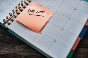 work calendar with a post it that reads "day off"