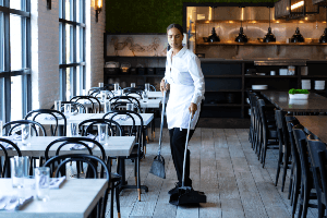 waitress cleaning up restaurant at close 
