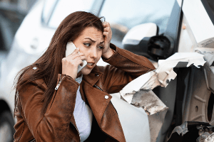 woman in distress over a car crash