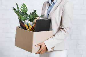 employee carting off with desk supplies in a box