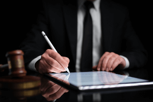 Man signing a digital document. 