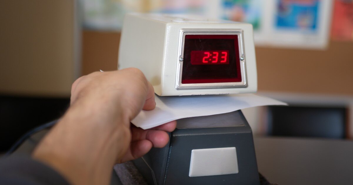 photo illustration of a hand punching in a time clock