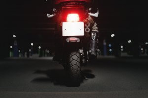 back of motorcycle on road at night