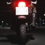 back of motorcycle on road at night