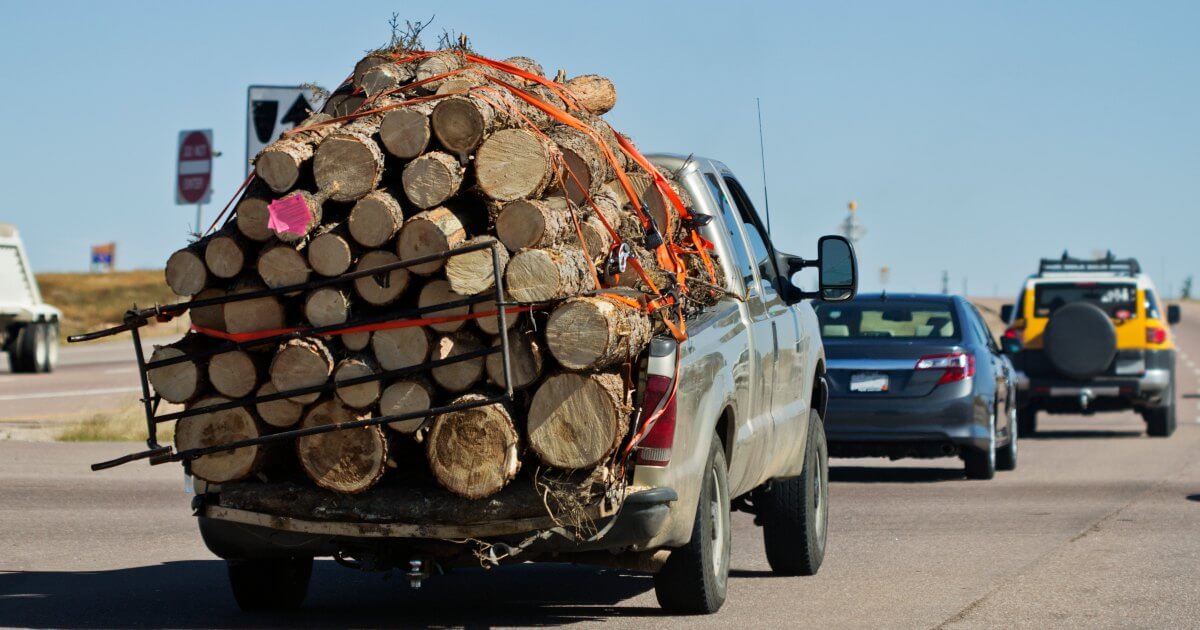 pickup truck loaded with logs