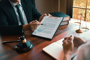 hands of lawyer explaining a contract to a client