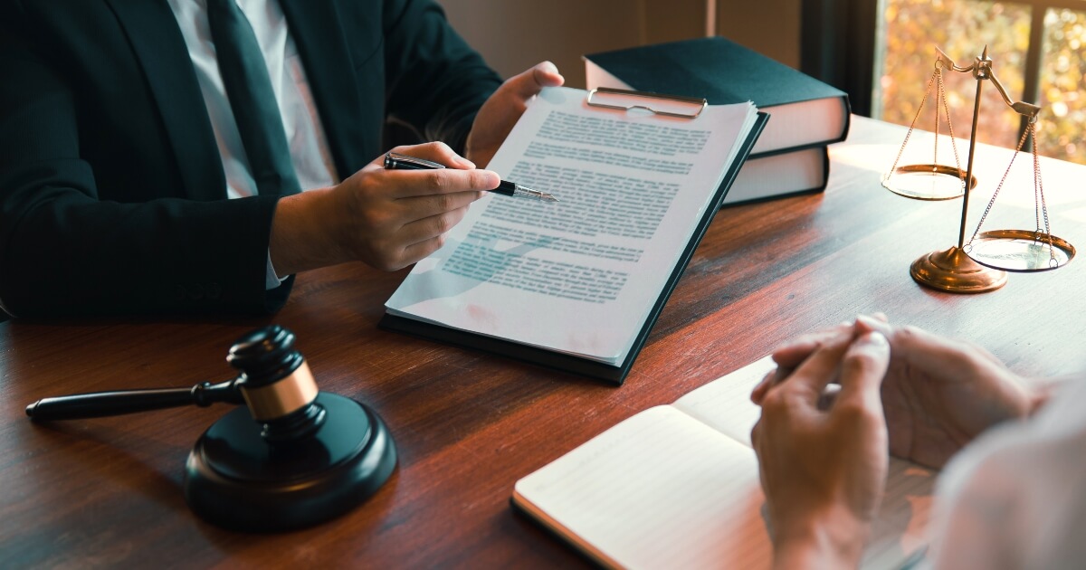 hands of lawyer explaining a contract to a client