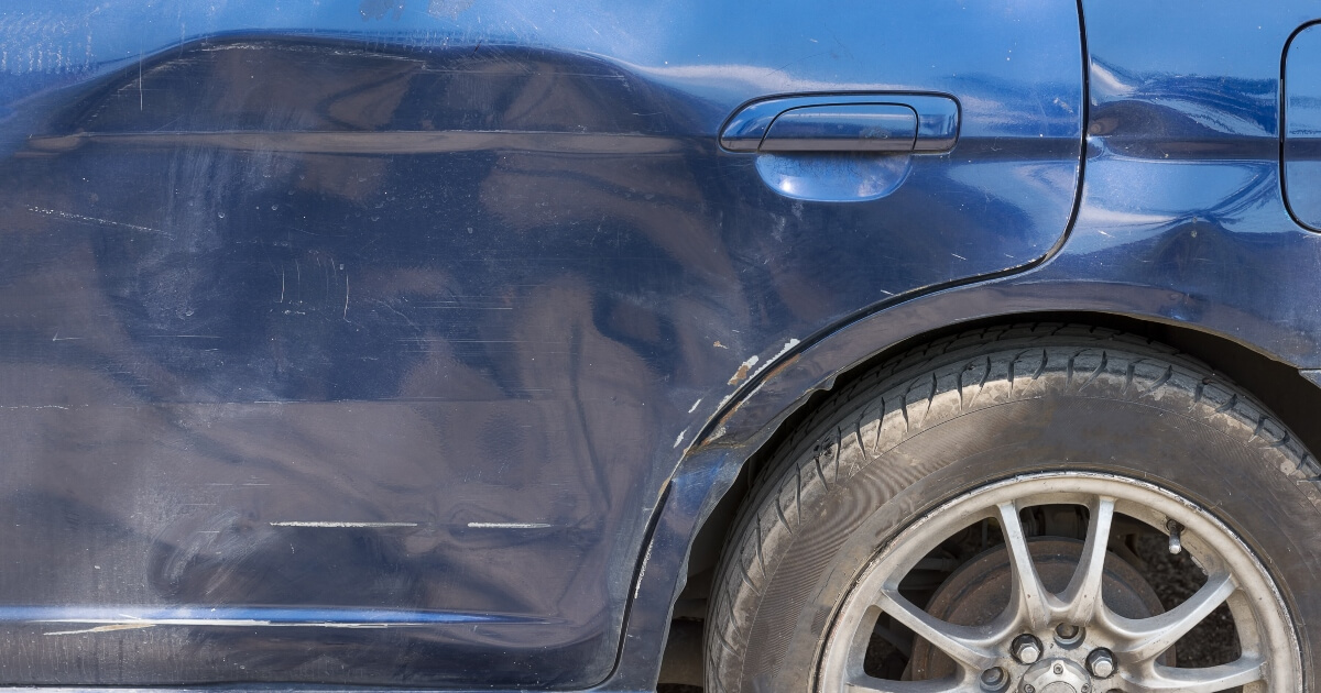 close-up image of the dented in side of a car caused by a T-bone crash.