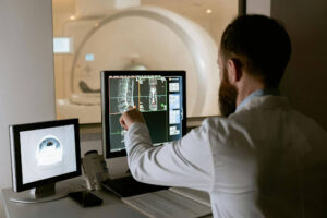 Broken bone injury doctor looking at scans after personal injury victim crash