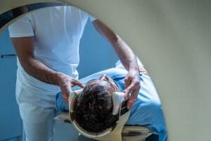 stock image of a male patient about to get a CT scan of his head