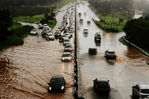 cars driving through flooded streets