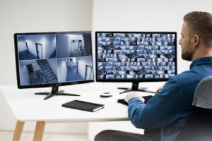 guy-watching-two-security-monitors