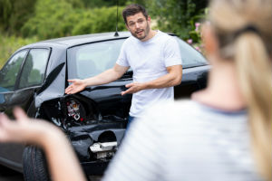 man-complaining-crash-black-car