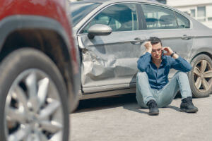 Injured victim on phone after car accident in Sacramento, CA