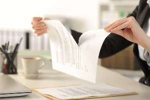 woman tearing a contract apart